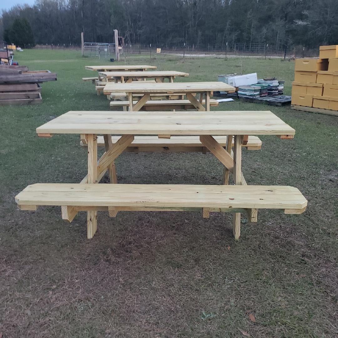 Wooden picnic table with attached benches